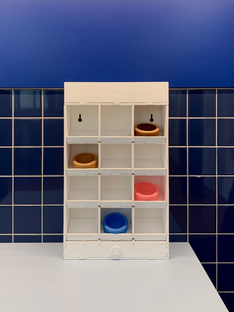 Photo of the prototype placed in front of blue tiles wall, common for kitchens 